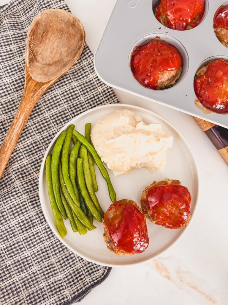 plate of mini meatloaf muffins with green beans and mashed potatoes