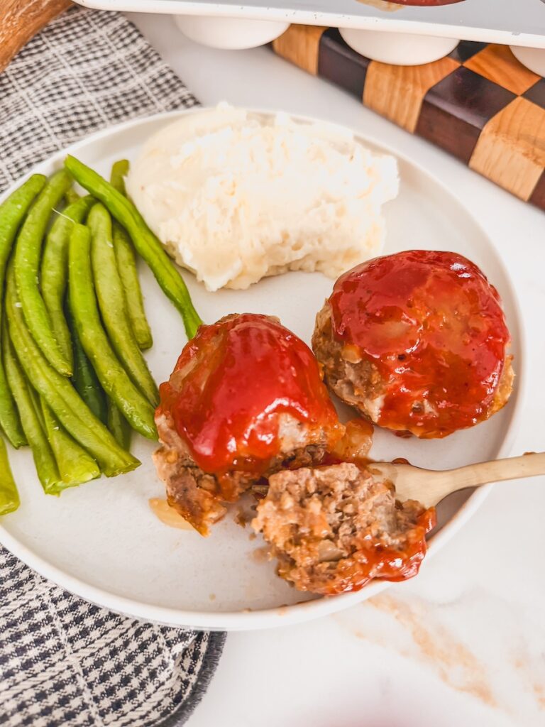 plated mini meatloaf muffins with green beans and mashed potato