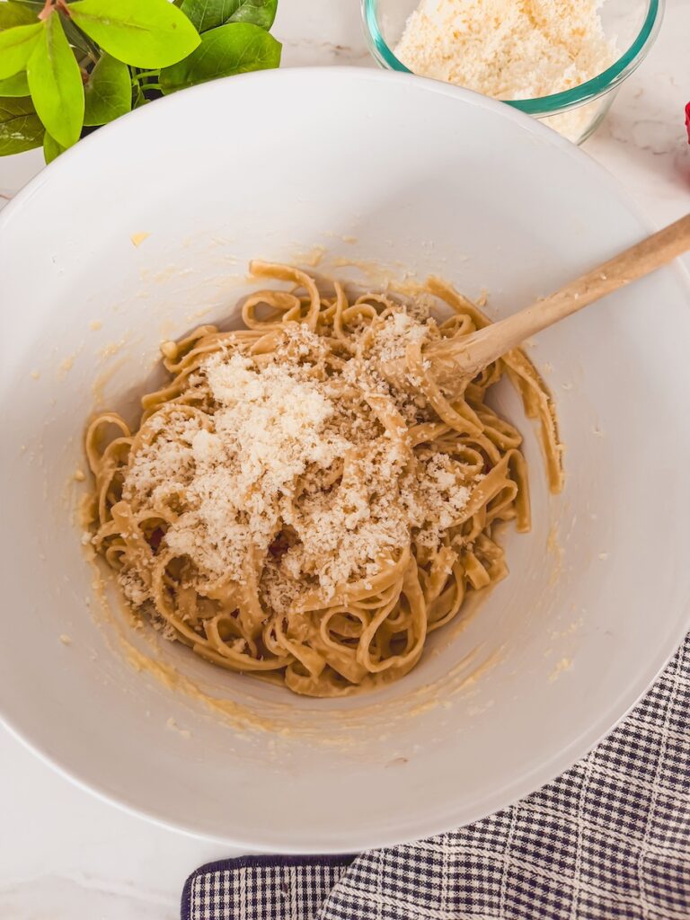 parmesan cheese added to pasta 
