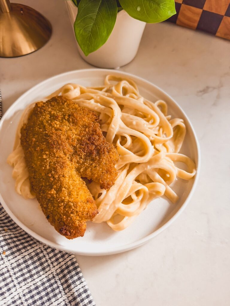 tilapia along side fettuccini alfredo