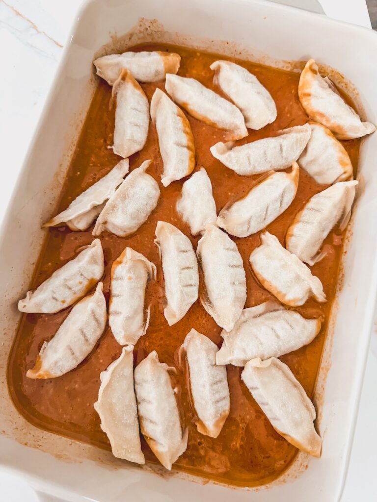dumplings on top of sauce