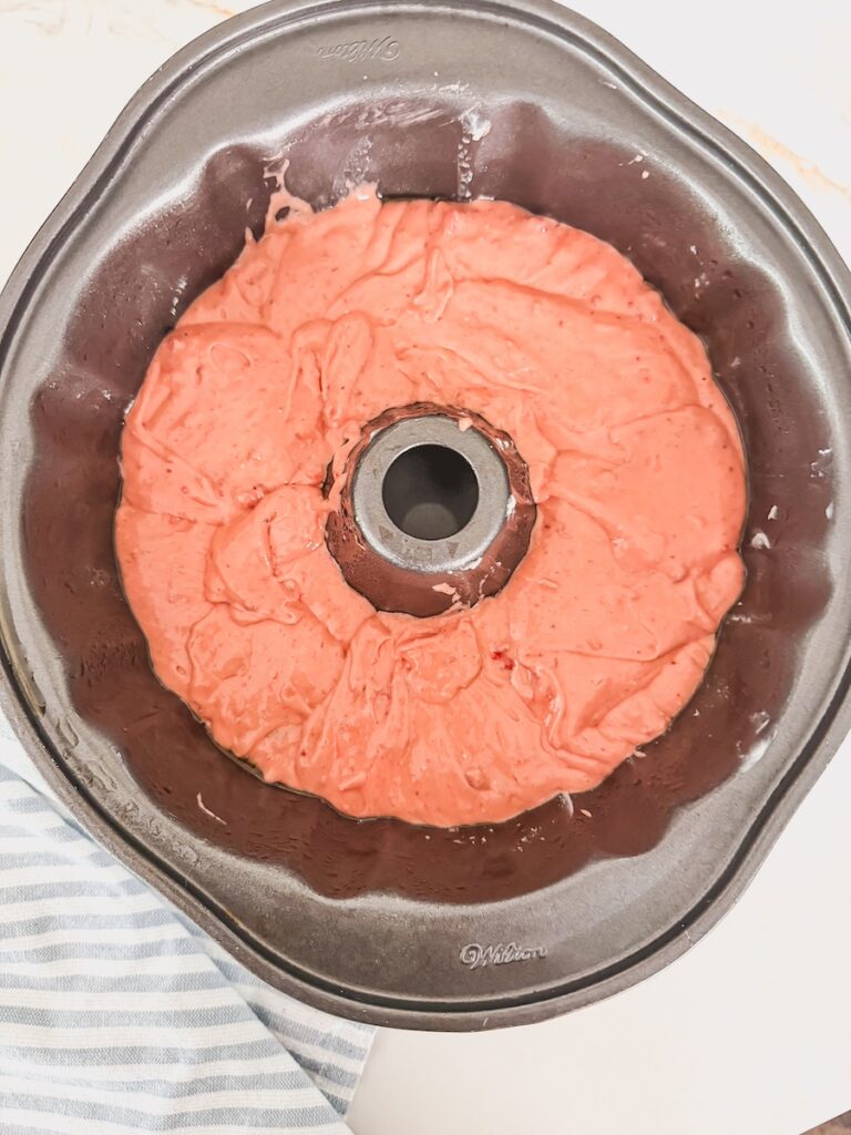 strawberry bundt cake batter unbaked in bundt pan