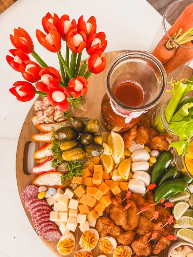 bloody mary board with cheeses, meats, tomato tulips