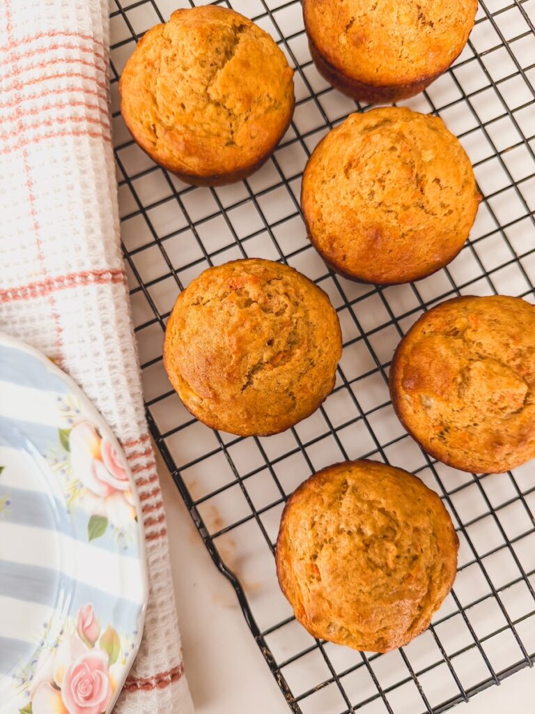 Carrot banana muffins are cooling on a wire rack.