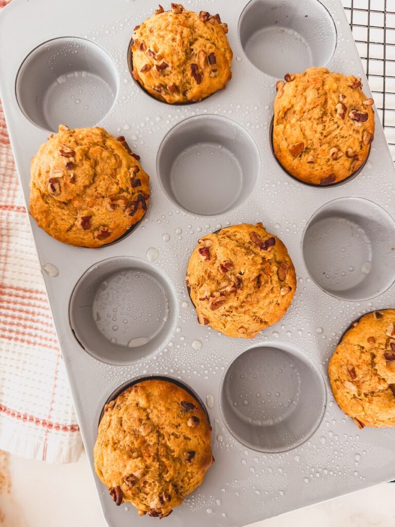 Carrot banana muffins are baked in a muffin tin.