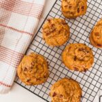 Overhead image of carrot banana muffins cooling on a wire rack.