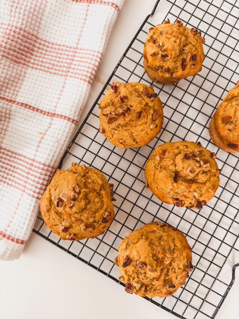 Overhead image of carrot banana muffins cooling on a wire rack.