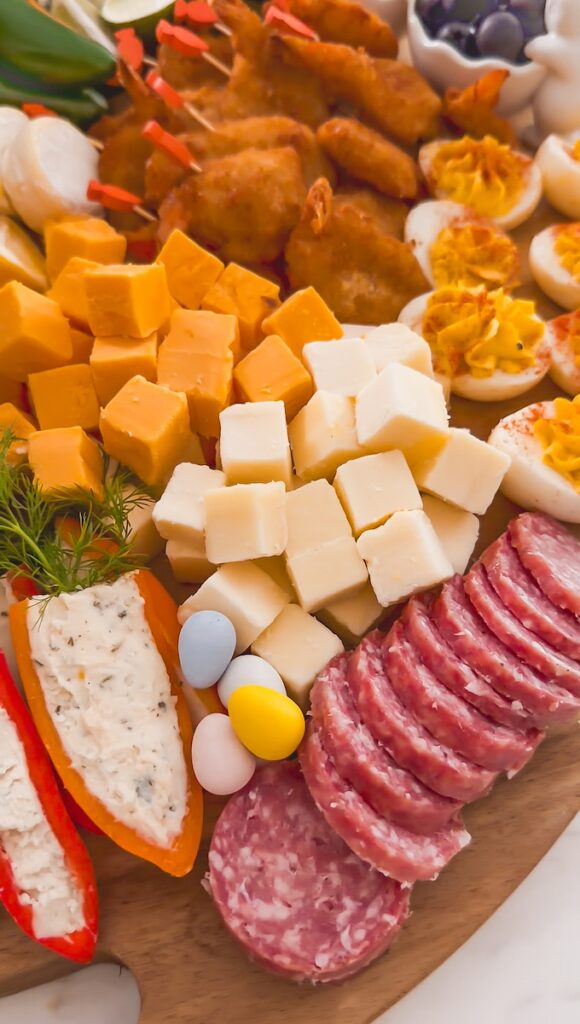 close up of cheeses and meats on board