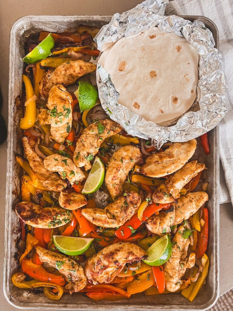Sheet pan chicken fajitas on sheet pan with tortillas