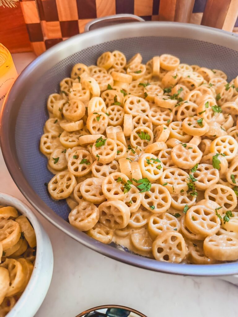 close up of creamy cheesy pasta coated in rich velvety sauce