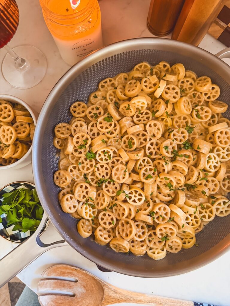 top view of creamy cheesy pasta in skillet with melted cheese