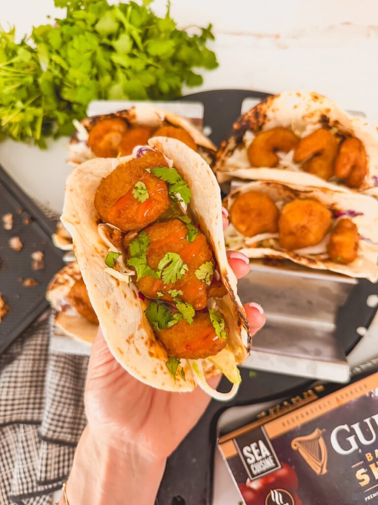 hand holding shrimp taco