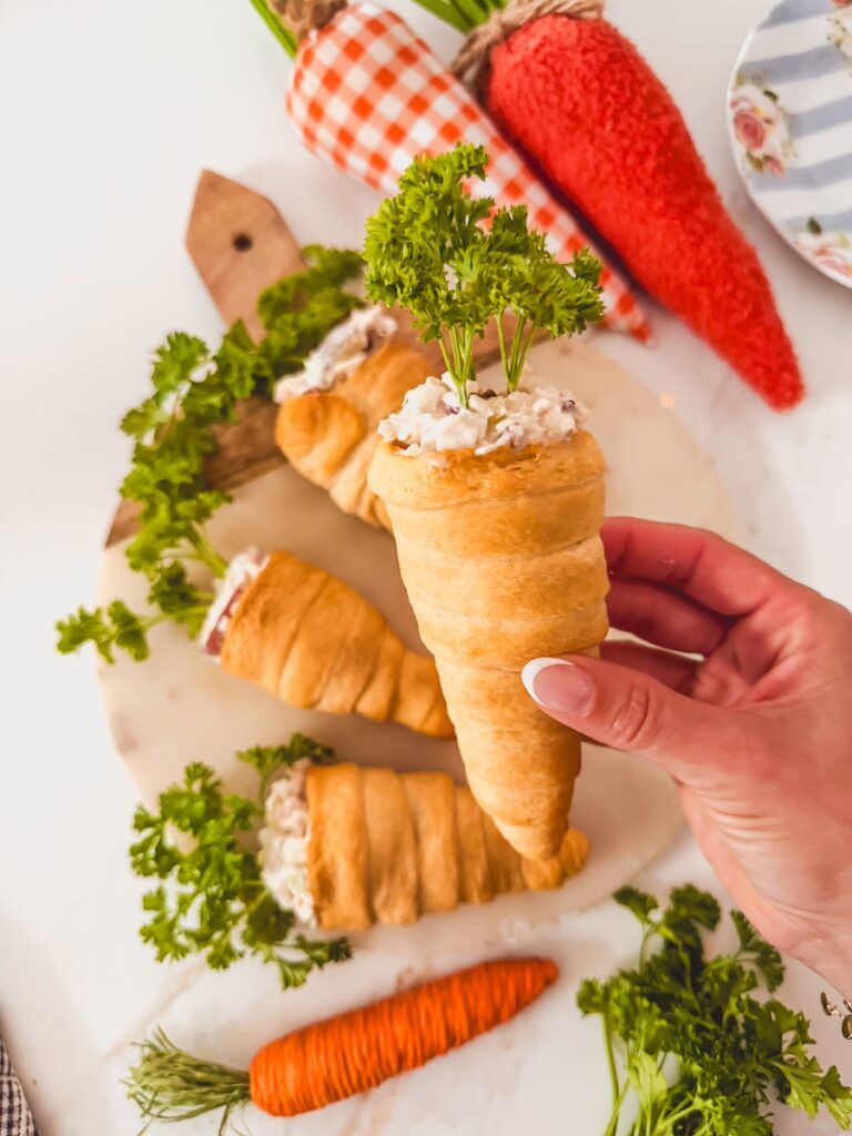 hand holding a chicken salad carrot