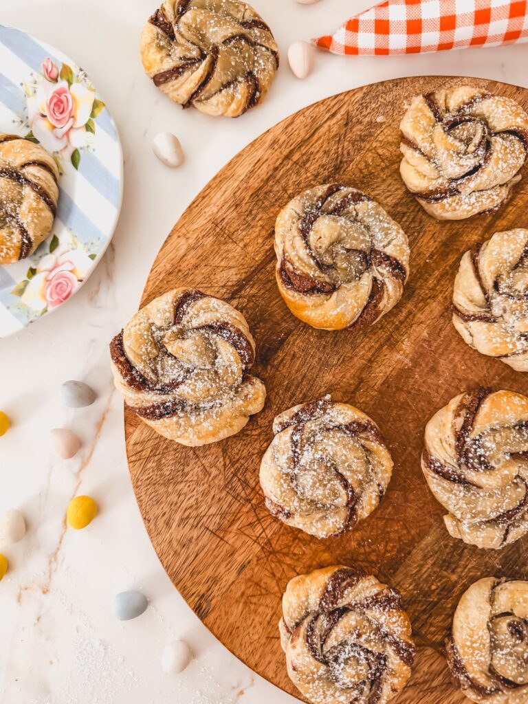 puff pastry nests on wood tray without eggs