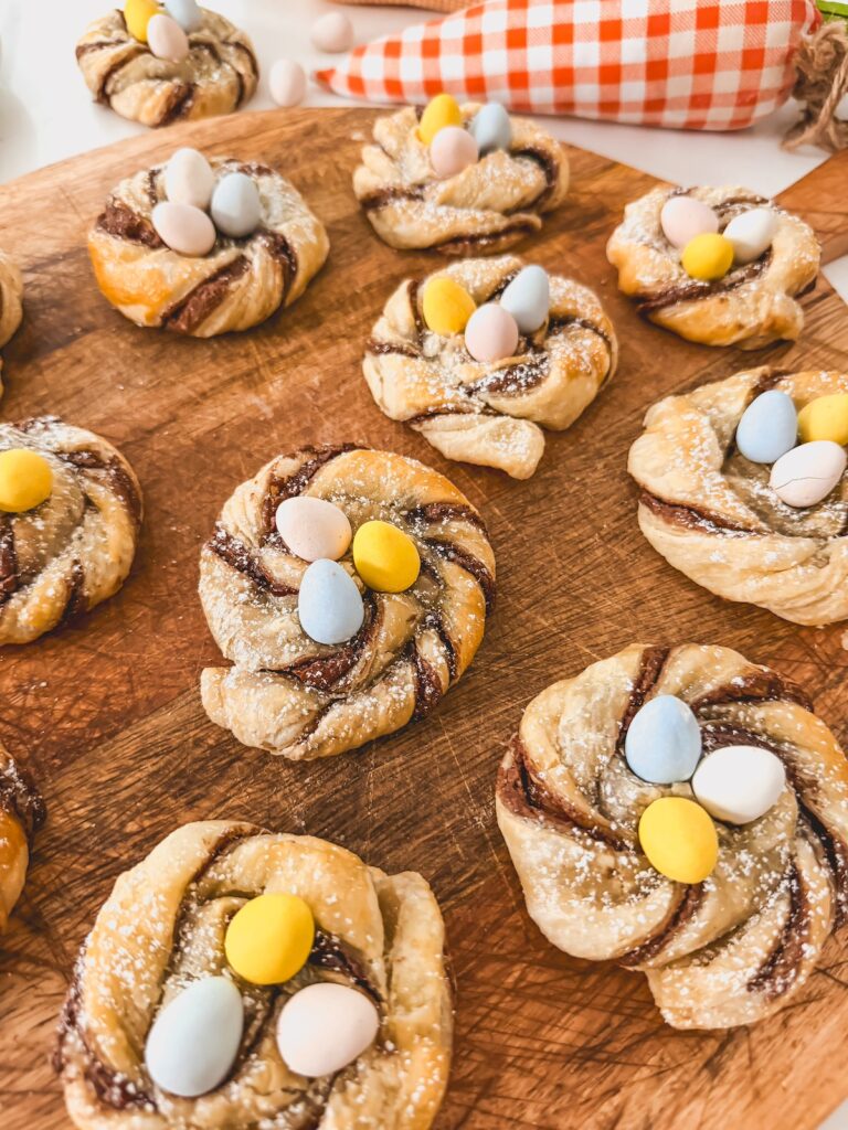 close up of puff pastry nests for easter on wood board