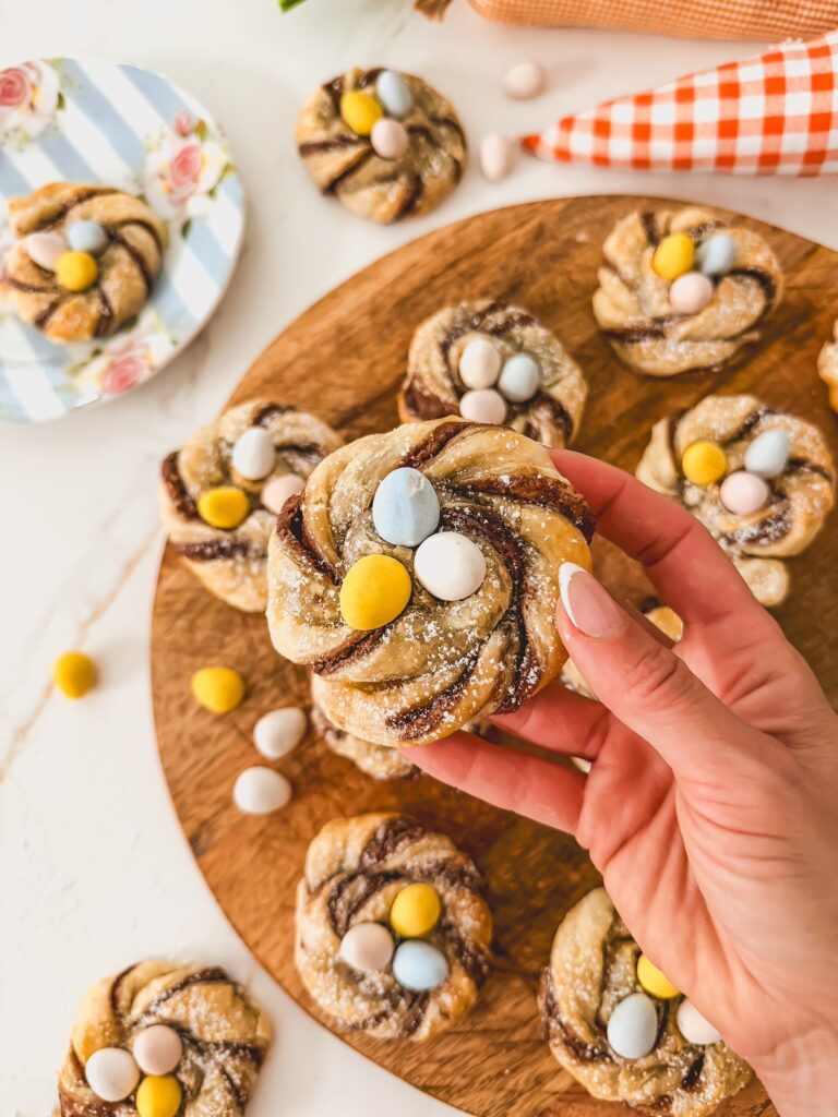 close up of hand holding puff pastry nest