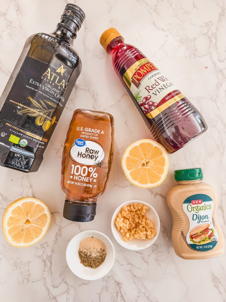 greek tortellini salad dressing ingredients on marble counter