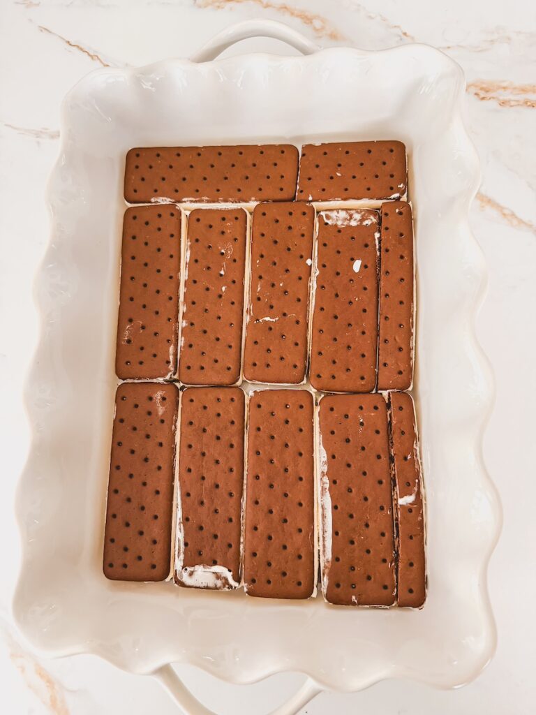 layer of ice cream sandwiches in bottom of white baking dish