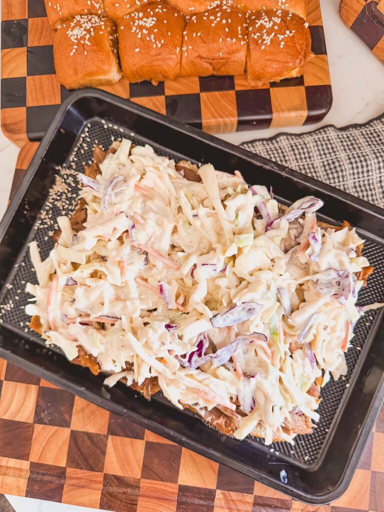 slider being assembled, topped with cole slaw