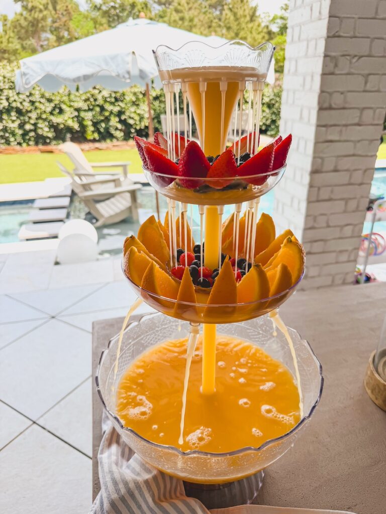 mimosa drink tower centerpiece with fresh fruit and berries