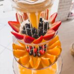 mimosa drink tower close up with berries and fruit