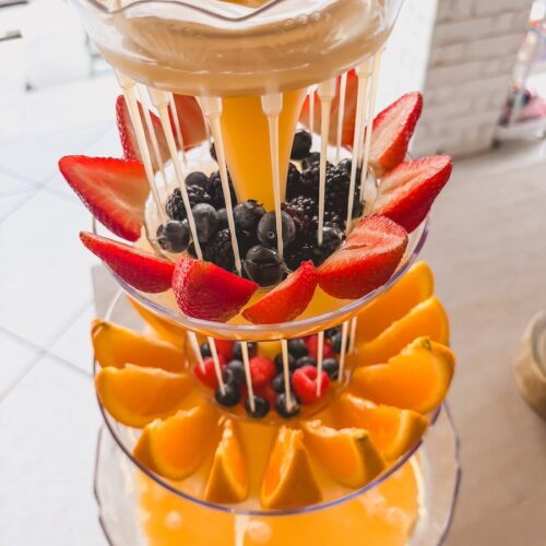 mimosa drink tower close up with berries and fruit
