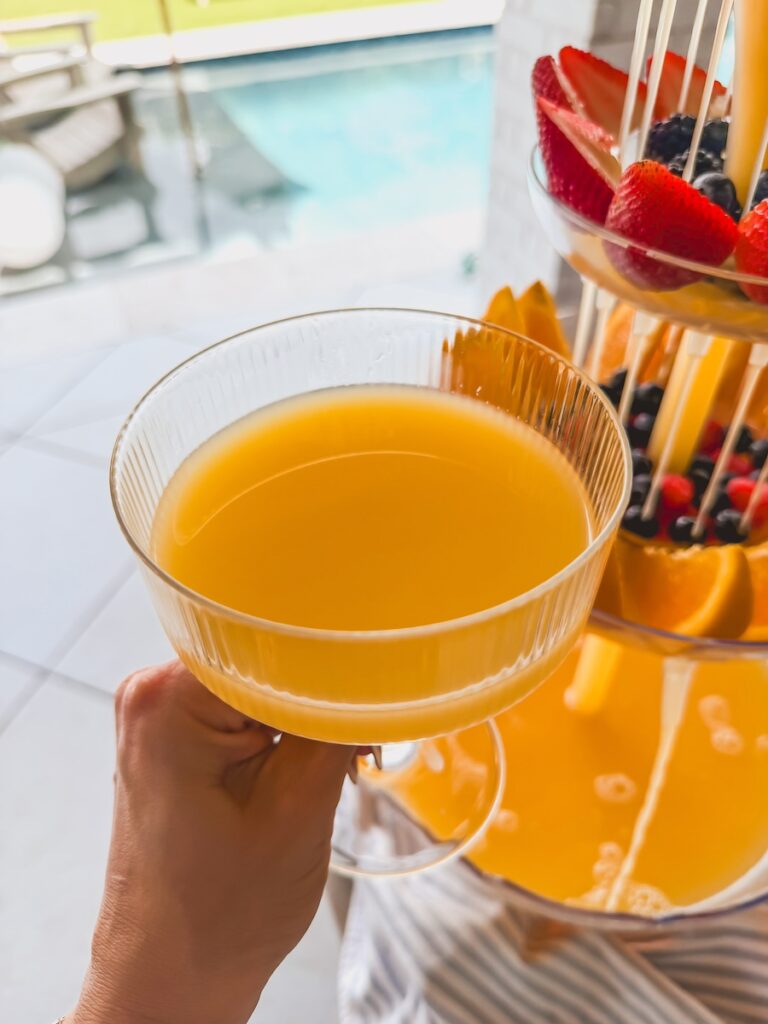 glass of mimosa with drink tower centerpiece