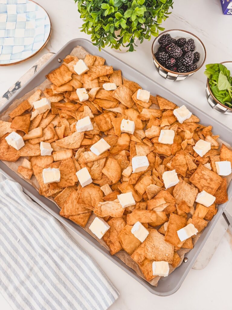 Brie scattered over chips before baking