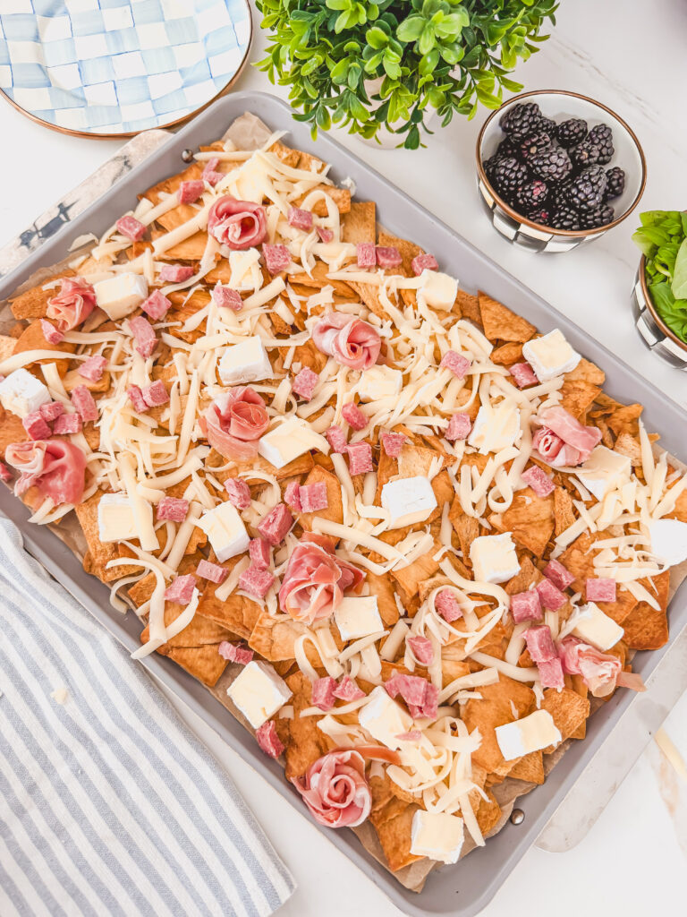 prosciutto, and salami scattered over chips before baking
