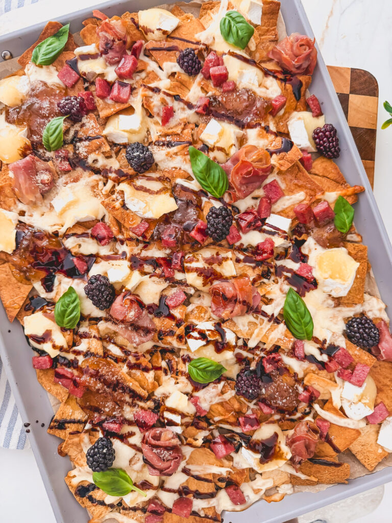 Summer appetizer with brie, blackberries, and fig jam on chips