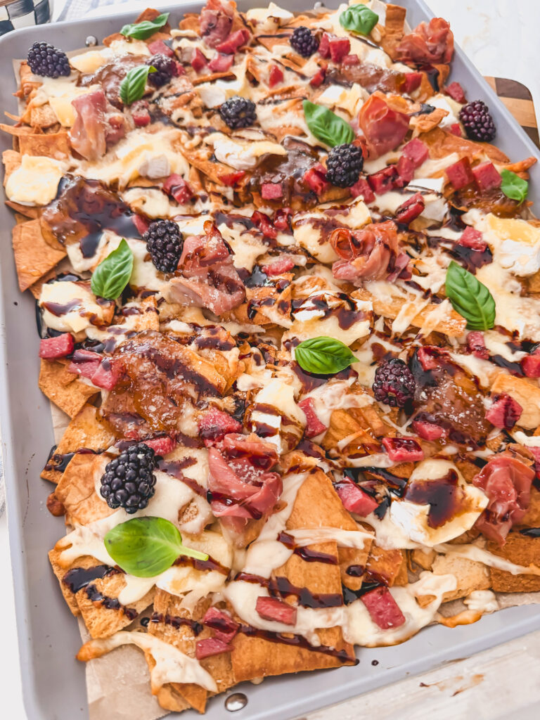 Hot honey and balsamic glaze drizzled over baked charcuterie chips with fresh basil