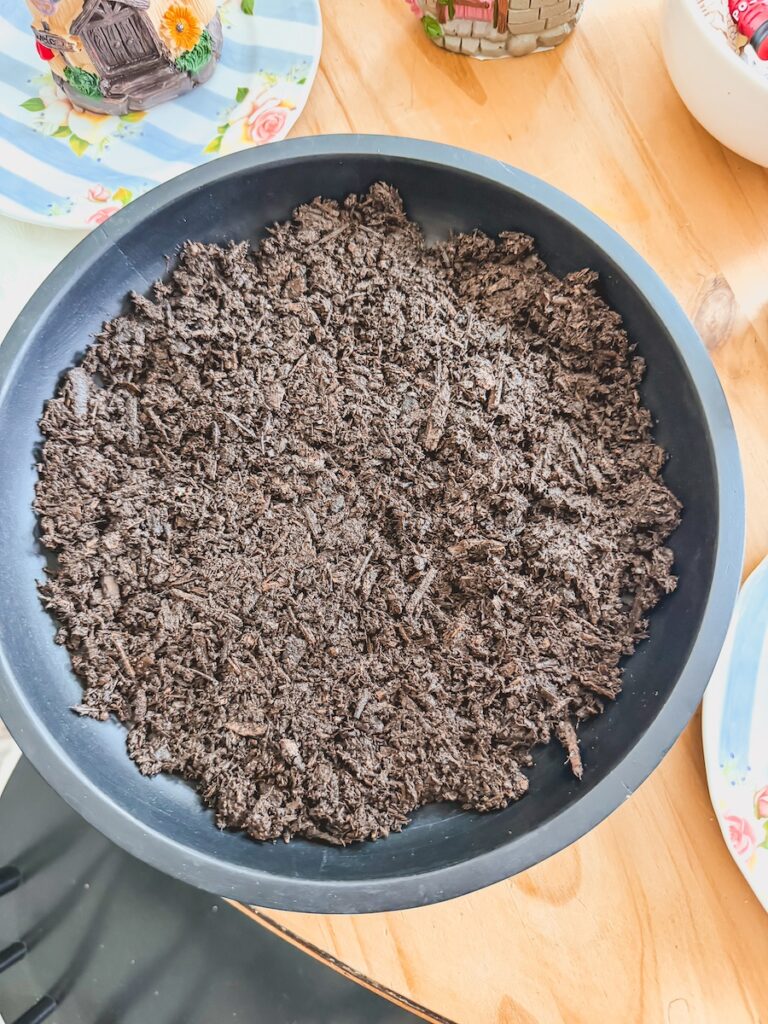 large black bowl with potting soil for fairy garden base