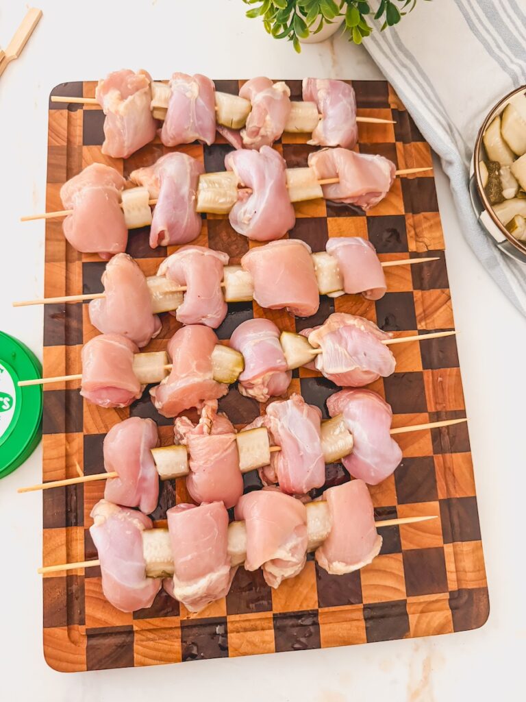 wood board of dill pickle chicken skewers
