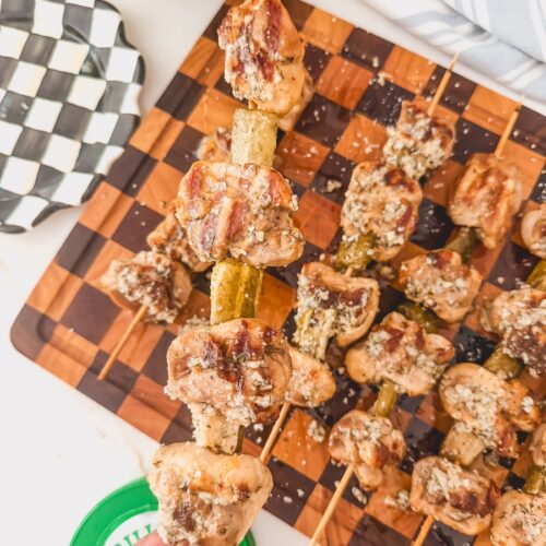 hand holding dill pickle chicken skewers