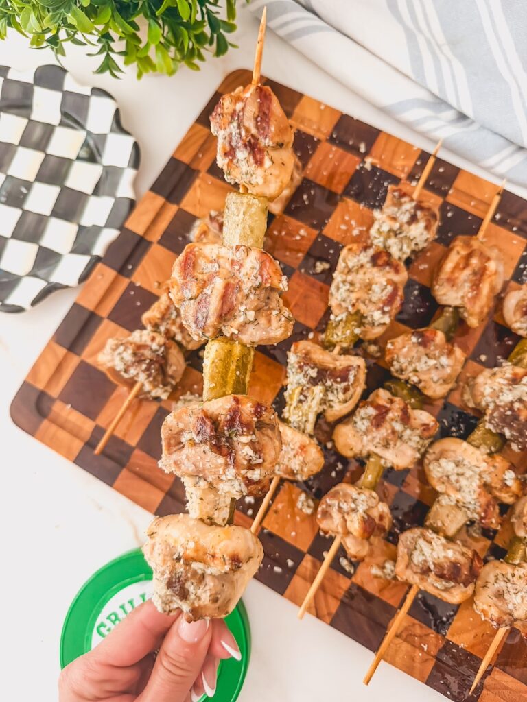 hand holding dill pickle chicken skewers