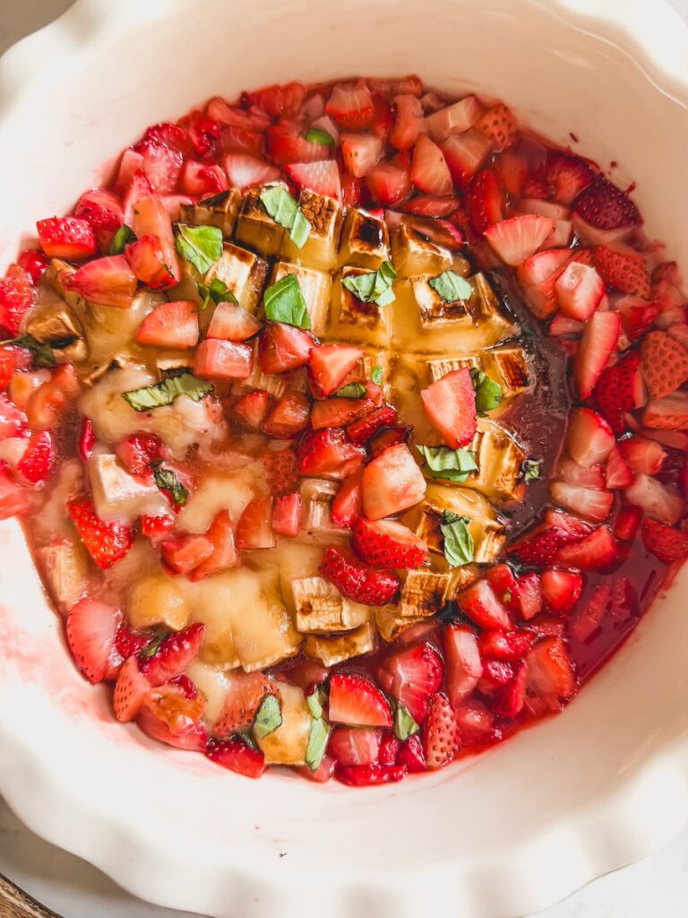 close up of melty brie with strawberries