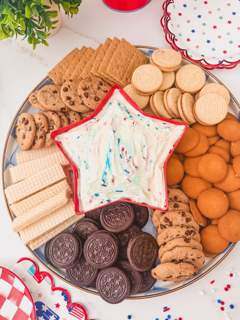 funfetti dip in star bowl surrounded by dippers like oreos, cookies, vanilla wafers