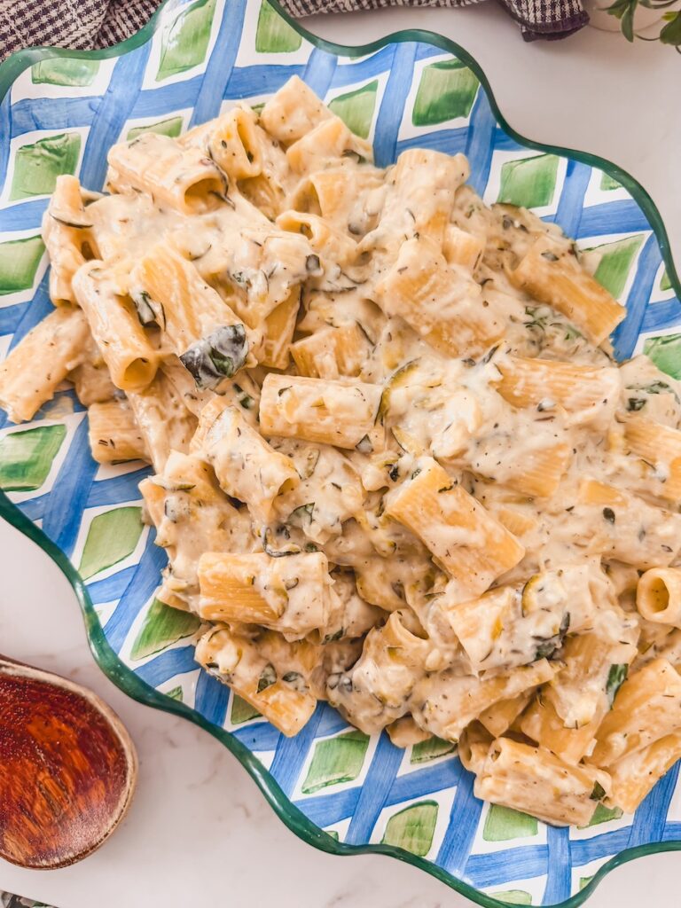 An overhead image of a platter with lemon zucchini garlic pasta.