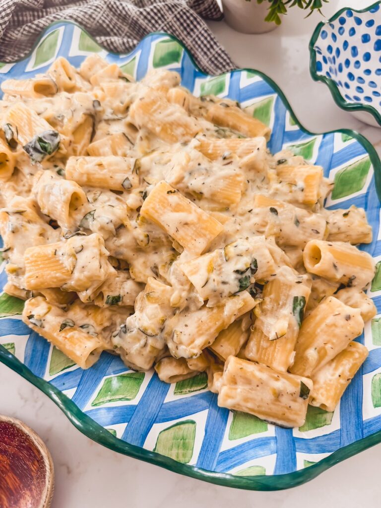 Lemon zucchini pasta on a blue and green platter.