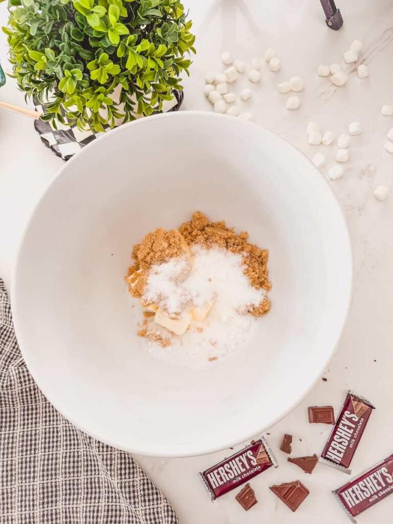 A large white bowl with butter and sugars.