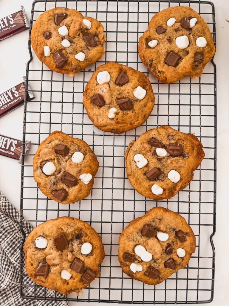 Smores cookies cooling on a black wire rack.