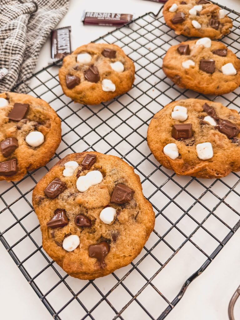 Smores cookies cooling on a black wire rack.