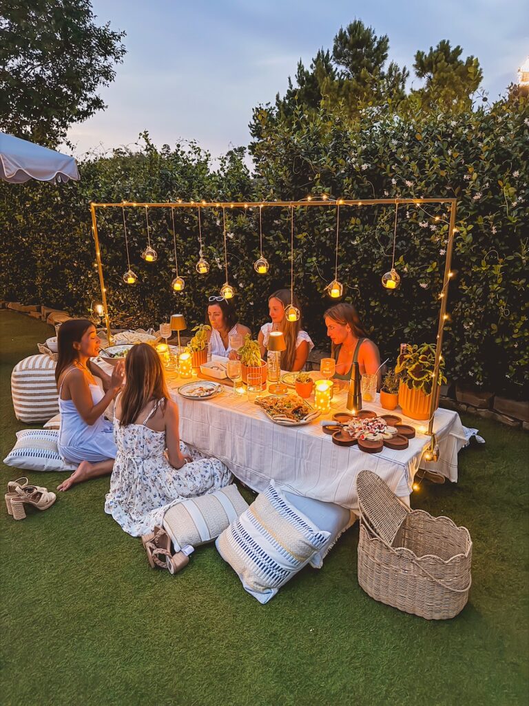 hanging lanterns above outdoor table set up for party