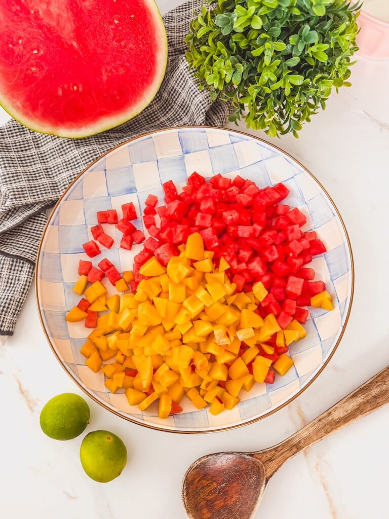 fresh cubed watermelon and peaches in a mixing bowl