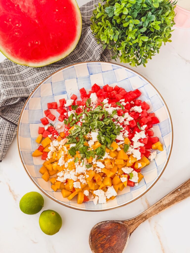 basil tossed in salad with feta, watermelon and peaches