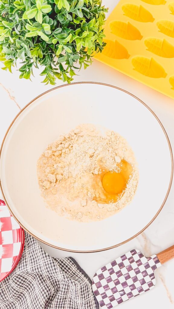 corn dog batter ingredients ready to be mixed in white bowl