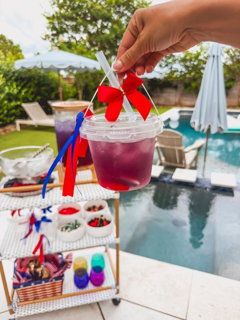 patriotic drink bucket with fruit and gummies for a kid friendly drink idea for the 4th of july