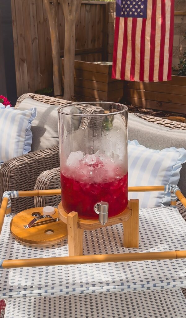 red cranberry juice poured in dispenser