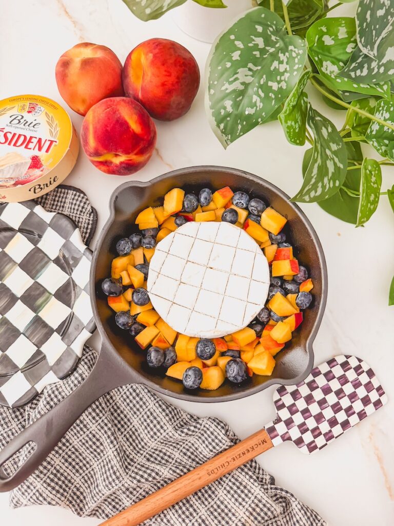 brie in skillet with peaches and blueberries