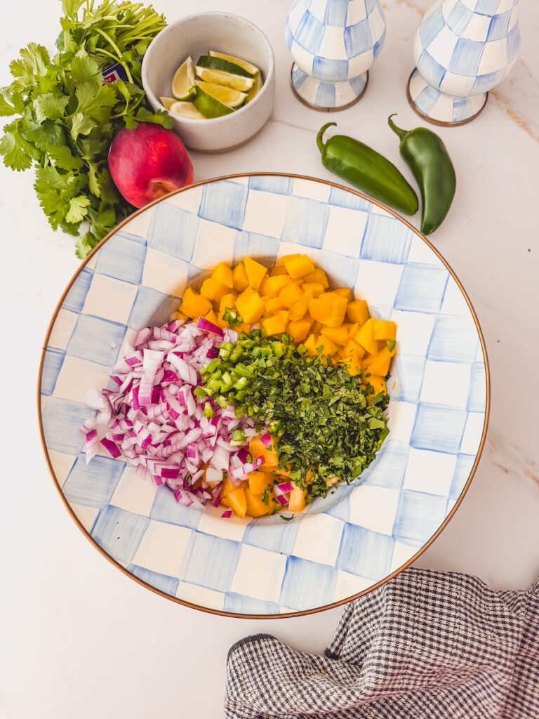 bowl of mango peach salsa ingredients combined together